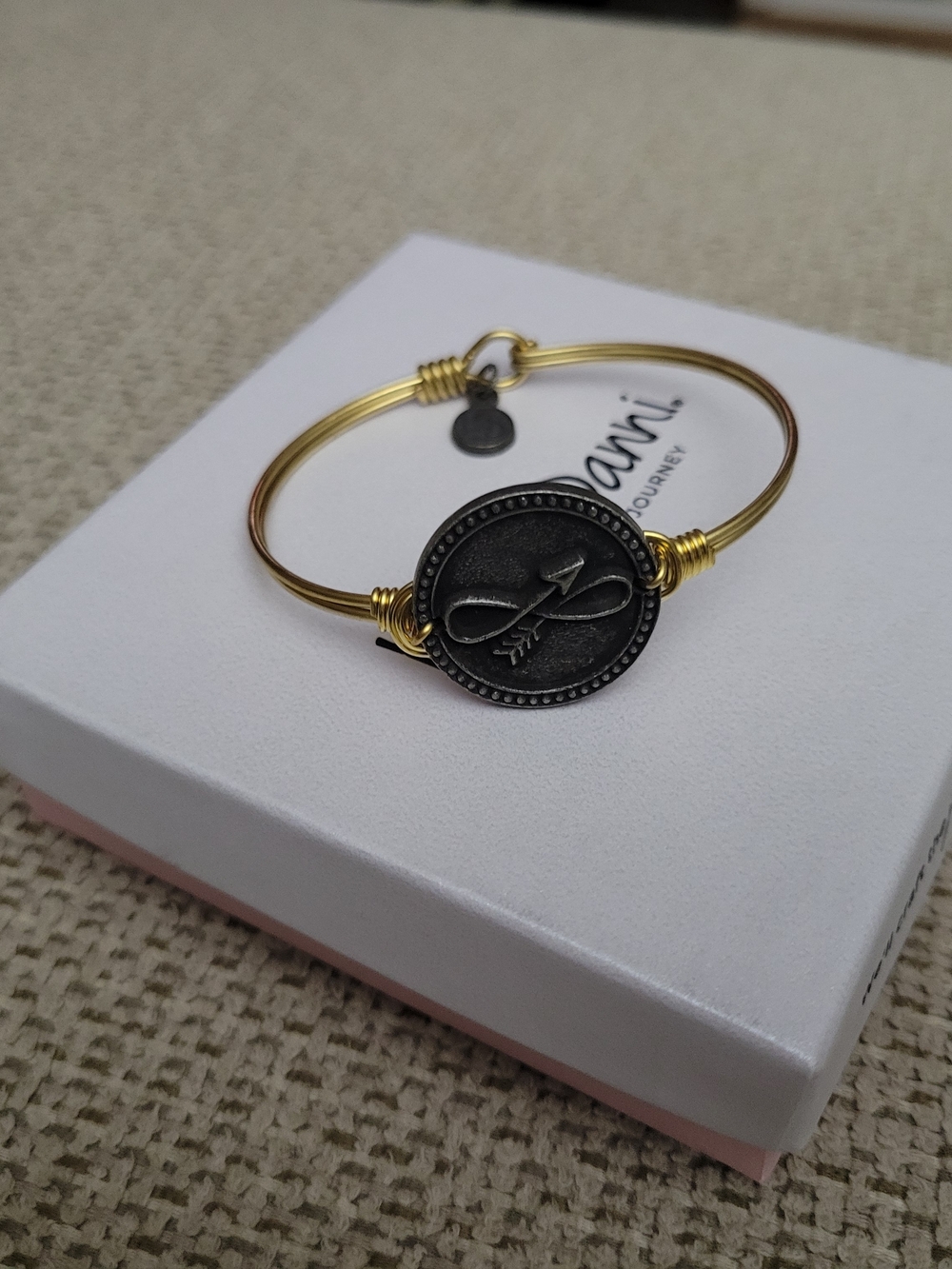 Luca + Danni Gold Wire Bangle with Dark Pewter Infinity & Arrow Medallion